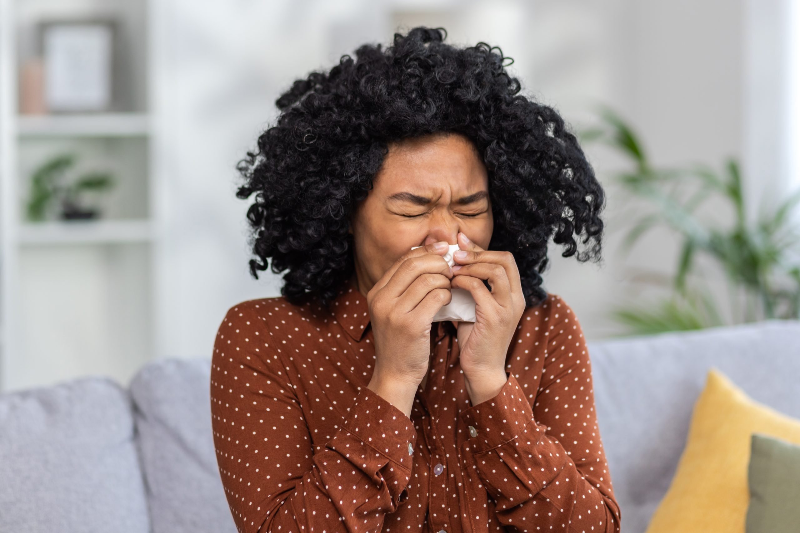 A woman sneezing