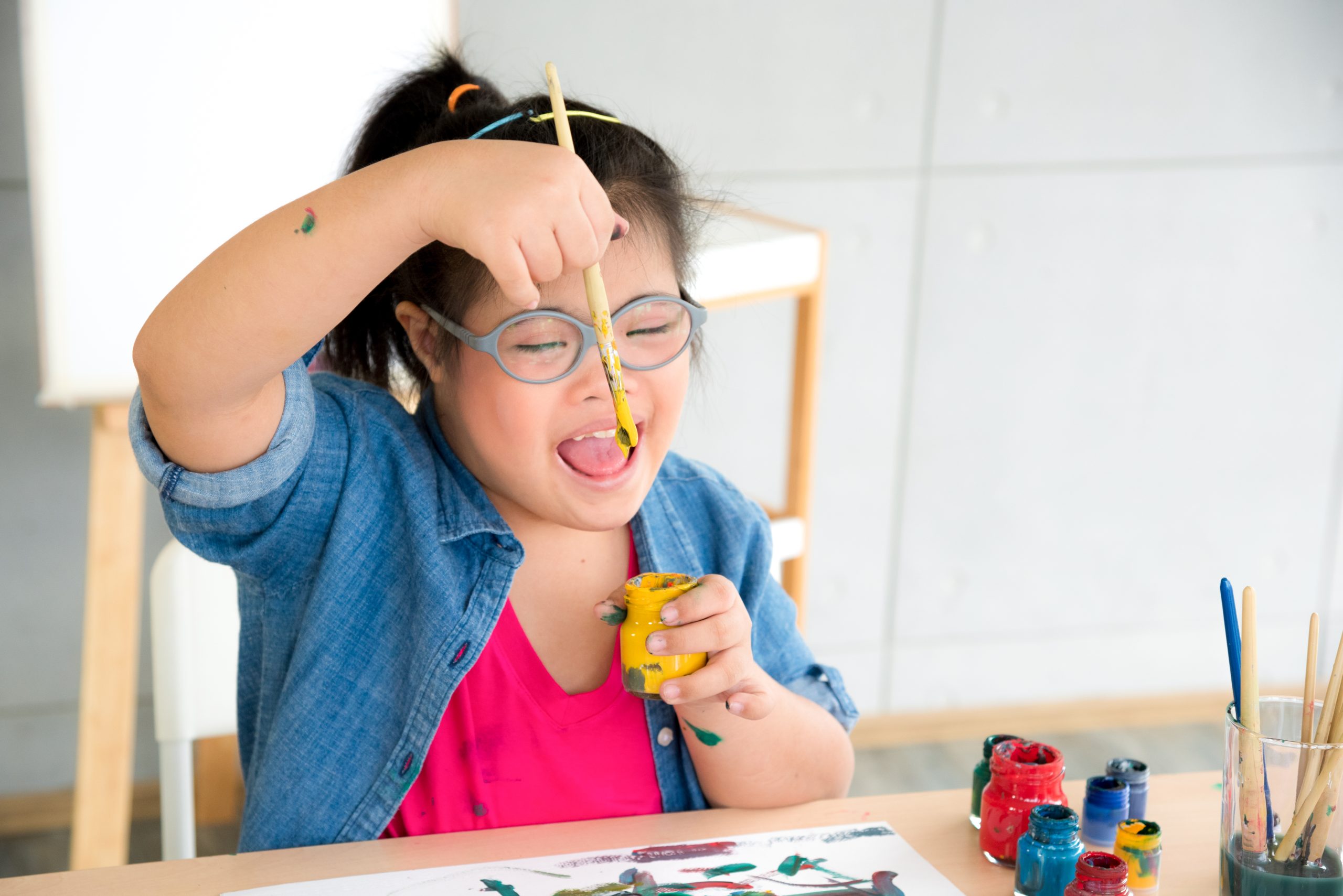 A child with ASD painting.