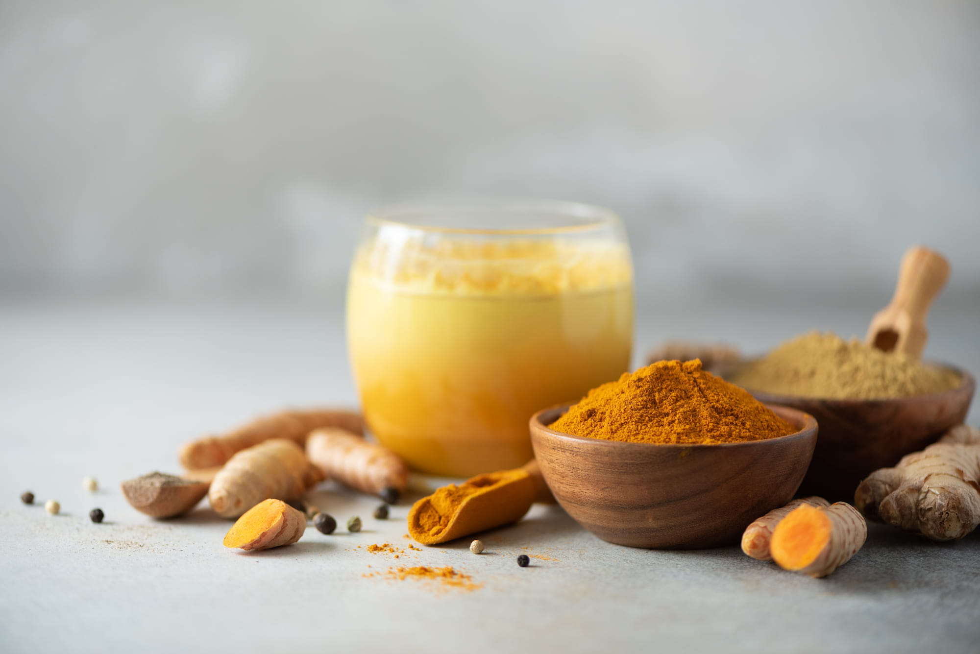 A close-up of curcumin supplement capsules and turmeric powder